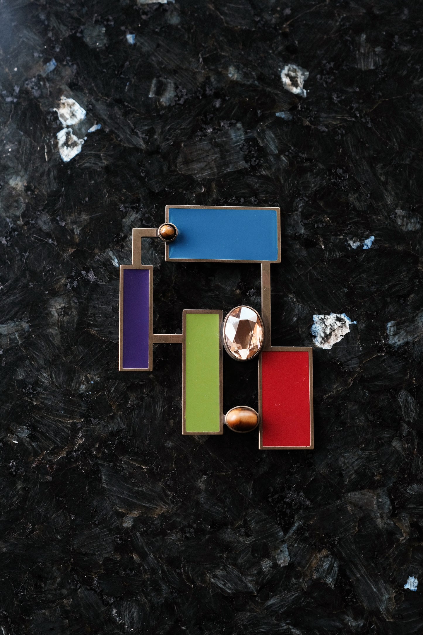 Suzanne Tiger's eye brooch pendant featuring Art Deco inspired geometric design and vibrant colored enamels.